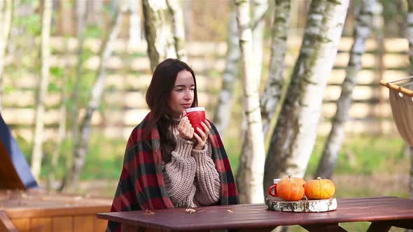 Woman Enjoying in Autumn Day While Drinking Coffee