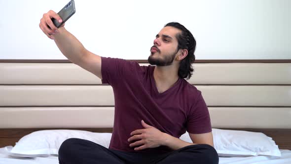 Indian man taking selfies alt