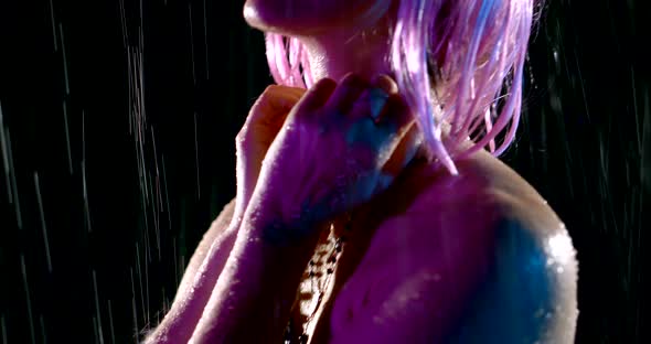 Portrait in Profile of a Woman with Pink Hair in the Rain in the Dark alt
