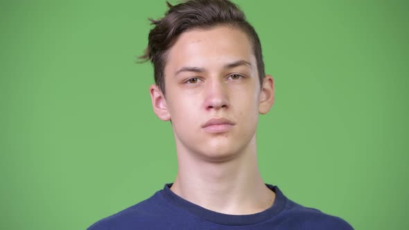 Young Handsome Teenage Boy Covering Eyes As Three Wise Monkeys Concept alt