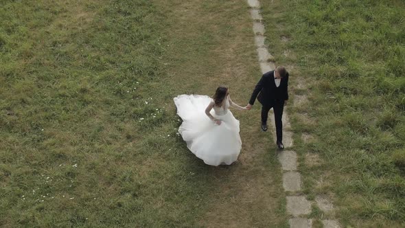 Caucasian Groom with Bride in the Park. Wedding Couple. Happy Family. Newlyweds alt