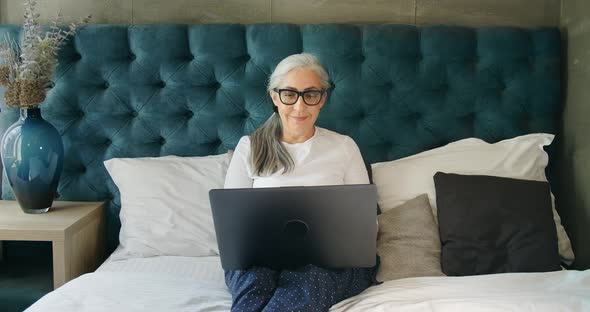 Elderly Woman Working on Laptop