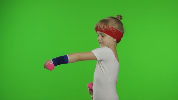 Caucasian Girl in Sportswear Making Exercises with Dumbbells. Workout for Kids. Athletic Child alt