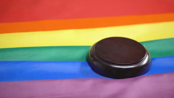Gavel Striking on Sound Block, Rainbow Flag on Table, Gay Community Legalization alt