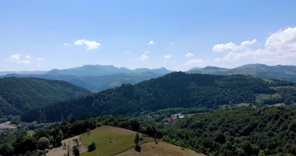 Small Village At The Valley Of Apuseni Mountain Range Of Western Romanian Carpathians. aerial alt