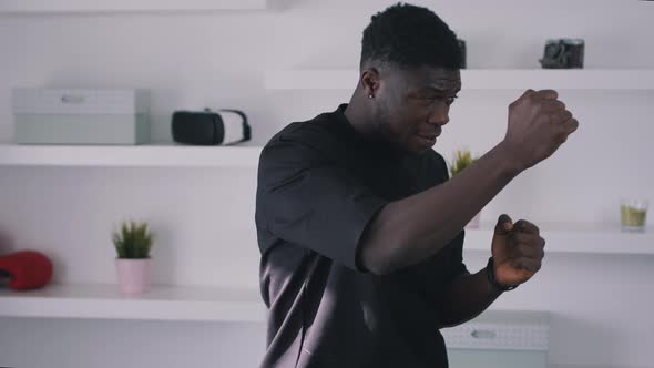 Black Guy Wearing a Fitness Belt Punch Boxing in the Air alt