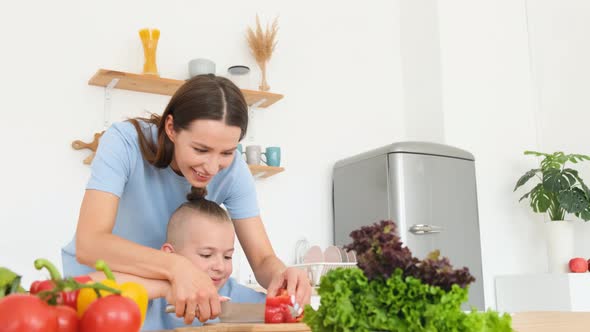 Happy Mother and Son Prepare a Healthy Breakfast They Cut Vegetables Prepare a Vegetarian Salad alt