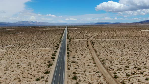 Aerial View of Endless Desert Straight Dusty Asphalt Road in Joshua Tree Park. USA. alt
