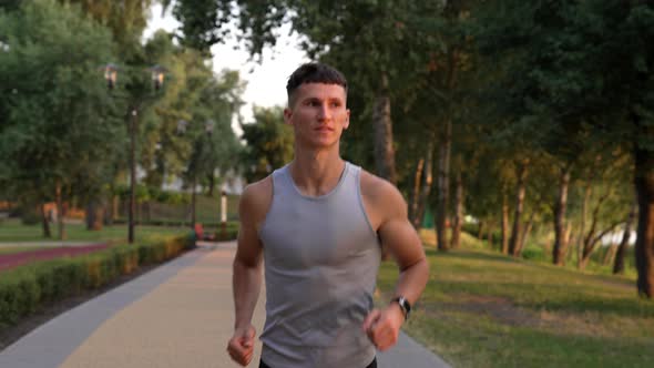 Athletic Man with Muscular Body Running in the Evening Outdoor Facing Sundown Motivation alt