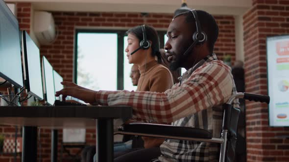 Young Man in Wheelchair Working at Customer Service alt