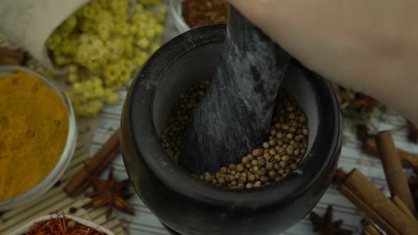 Woman's hand mixes and crushes coriander