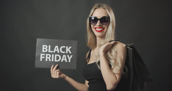 Happy Woman with Black Friday Posters