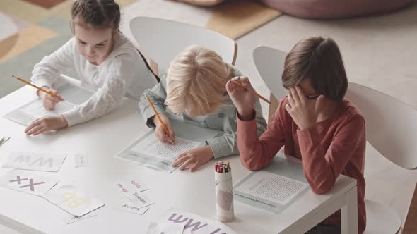 Kids Doing Exercises on Word Search in Classroom alt