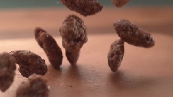 Pralines falling onto wooden surface in super slow motion.  Shot on Phantom Flex 4K high speed camer