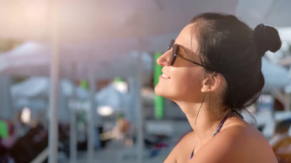 Smiling Tanned Young Tourist Female Enjoying Sunbathing During Summer Vacation Medium Closeup alt