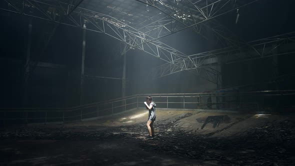 4K Asian woman boxer practicing boxing exercise punching the air in abandoned building. alt