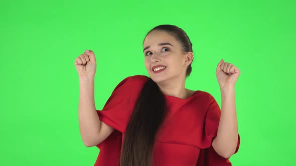 Portrait of Pretty Young Woman Is Dancing Funny. Green Screen alt