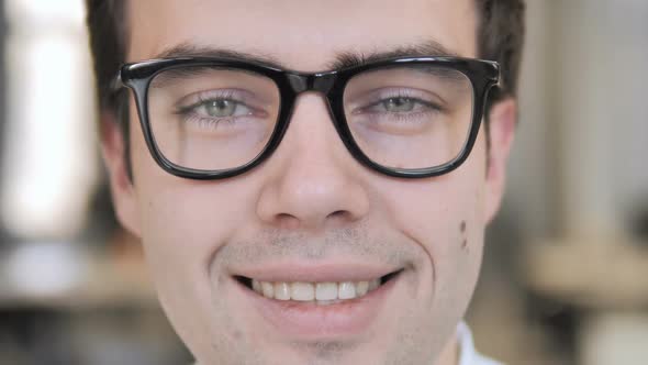 Close Up of Smiling Man Face in Glasses alt