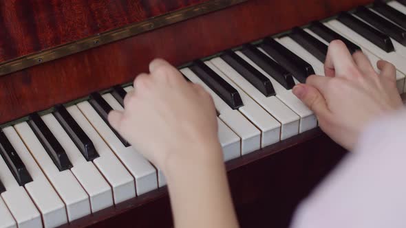 Young Musician Gives Demonstration Performances on Playing the Piano in Closeup alt