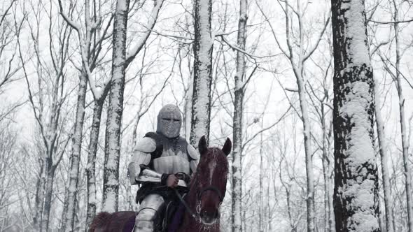 Portrait of Brave Medieval Knight Wearing Steel Protection and Helmet Being Horseback on Battlefield alt