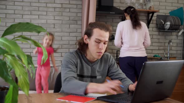 A student studies remotely at home with his family. Education during Covid 19 lockdown alt