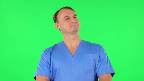 Medical Man Stands in Expectation Then Proudly Smiles. Green Screen alt