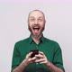 Happy bearded man looking surprised using mobile phone over white background. - VideoHive Item for Sale