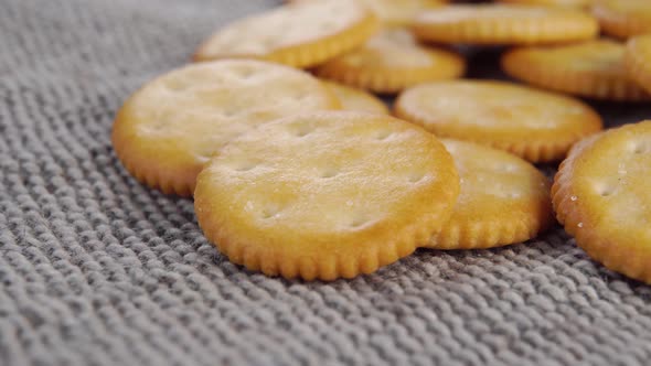 Round crispy crackers on a gray rough rustic jute cloth. Macro, Stock ...