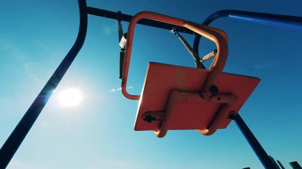 Playground Swings with Nobody on Them Are Swaying alt