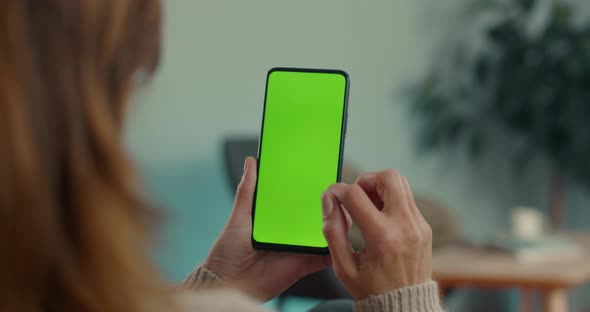 Woman Doing Swipe Up on Chroma Key Screen of Mobile alt