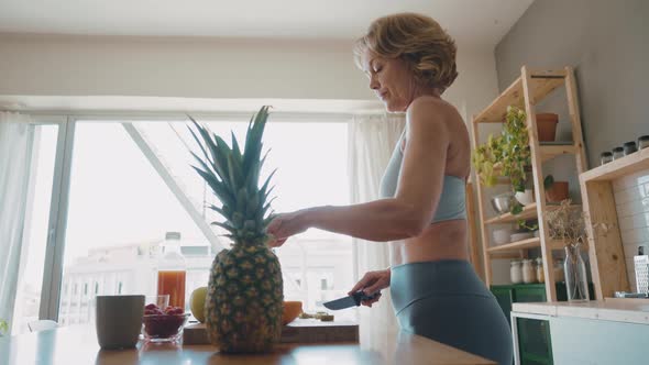 Woman preparing fruits and juices for breakfast alt