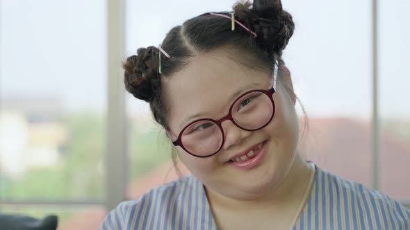 girl with Down syndrome, smiling.