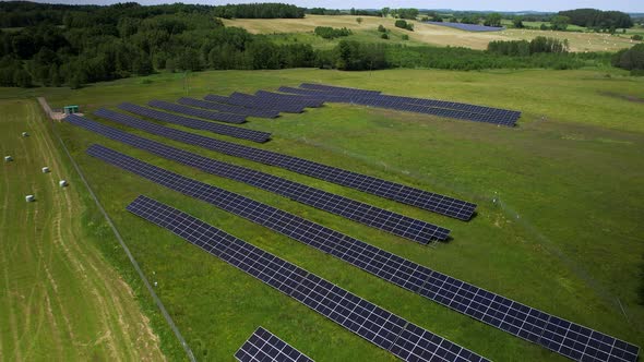 Solar panel arrays on farmland. Aerial shot of green energy. alt