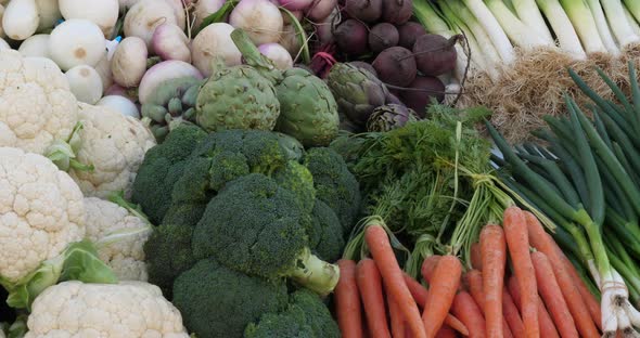 Fresh vegetables on stalls in a southern France market. alt