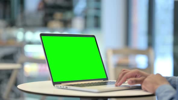 Man Using Laptop with Green Chroma Key Screen Close Up alt
