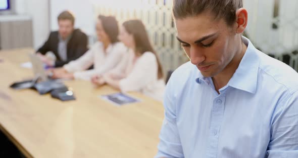 Male executive using digital tablet in conference room 4k alt