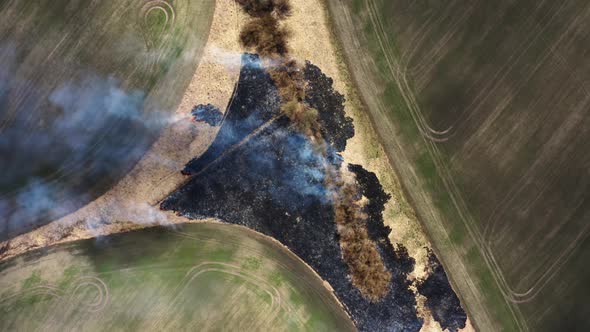 Aerial Top View of Wild Fire in Bartinney Nature Reserve in west Cornwall, South Africa. alt