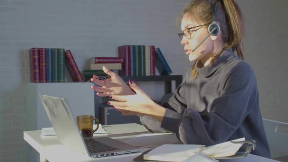 Footage of a Woman Works in Front of a Laptop Monitor in Office  She Having Online Video Call