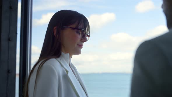 Young Businesswoman Talking Worker at Panorama Window Closeup alt