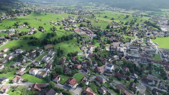 Aerial View of Liechtenstein with Houses on Green Fields in Alps Mountain Valley alt