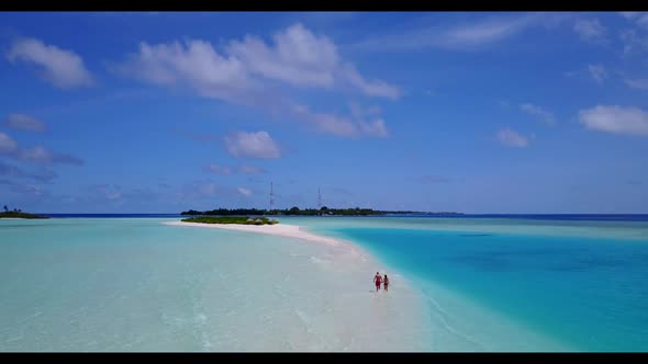 Romantic couple relax on beautiful island beach wildlife by shallow ocean and white sandy background alt