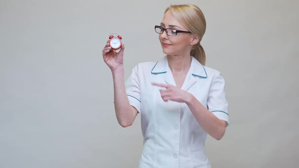 Nutritionist Doctor Healthy Lifestyle Concept - Holding Red Alarm Clock alt