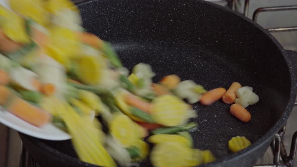 Close up view of steaming frying pan and mixed vegetables. Vegetarian alt