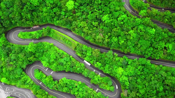 Winding Road with Transport Traffic Among Green Lush Forest Trees in Taroko Gorge National Park alt