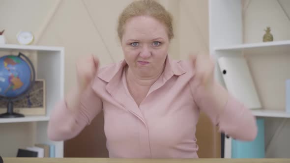 Portrait of Furious Senior Woman Pounding Fist on a Table. Angry Caucasian Lady Expressing Hate As alt