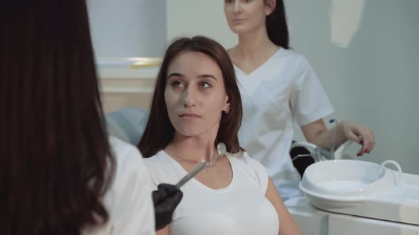 Beautiful Girl Sits on Dentist Consult in Chair and Smiling alt