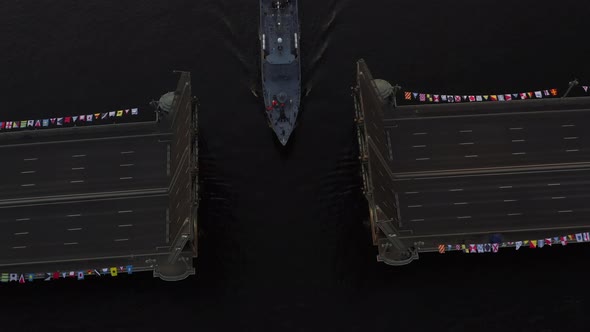 Aerial Landscape of Warship Pass Under a Raised Palace Drawbridge Top View Black Color of Water the alt