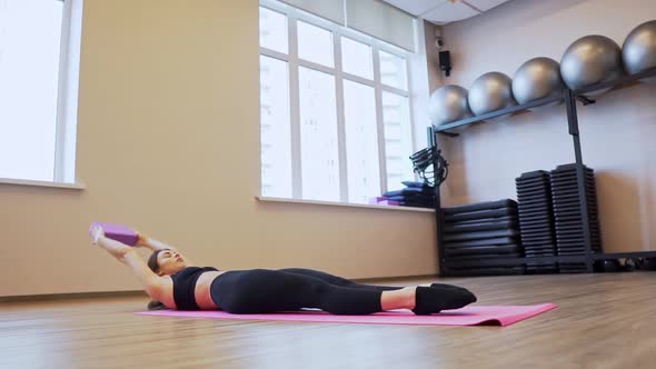 4x Slow Motion Video of Beautiful Young Woman Working Out and Stretching Indoors alt