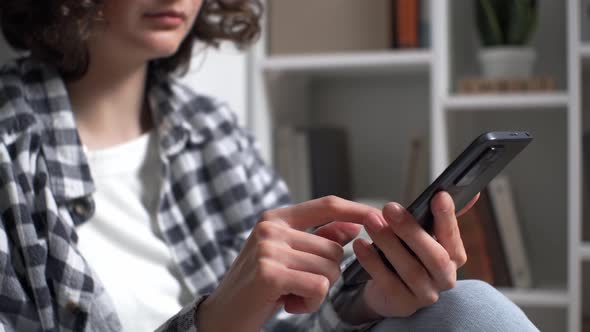 A Young Girl Student Presses A Letter To Her Friend On The Touch Screen Of A Smartphone. Telling alt