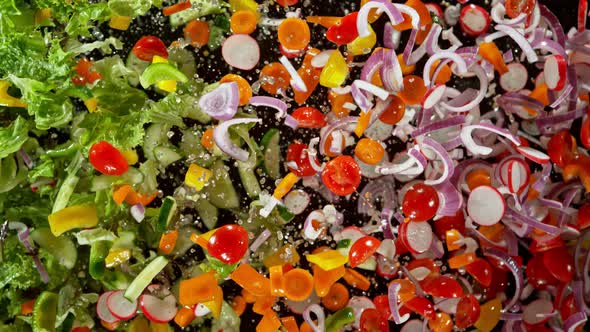 Super Slow Motion Shot of Flying Cuts of Colorful Fresh Vegetables and Water Drops at 1000Fps. alt